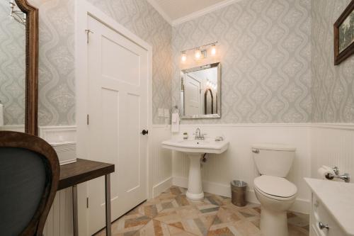a bathroom with a toilet and a sink at The Kendall in Boerne