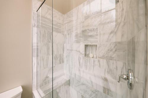 a bathroom with a shower with a glass door at The Kendall in Boerne