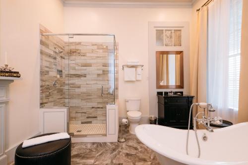 a bathroom with a tub and a glass shower at The Kendall in Boerne
