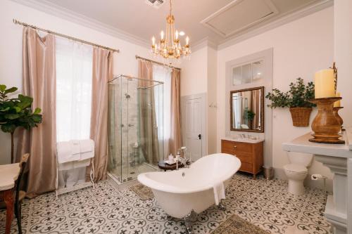 a bathroom with a tub and a shower and a sink at The Kendall in Boerne