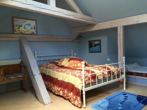 a bedroom with a bunk bed and a ladder at L'estaminet de la vallée - Le provençal in Russ