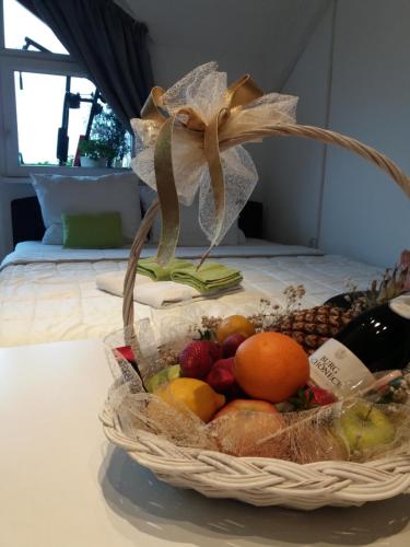 a basket of fruit sitting on a table at APARTMANI Emerald Dream in Novi Sad