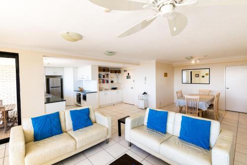 
a living room filled with furniture and a tv at Burgess @ Kings Beach Apartments in Caloundra
