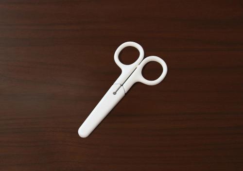 a white pair of scissors sitting on top of a table at Hotel Sports Palko in Gifu
