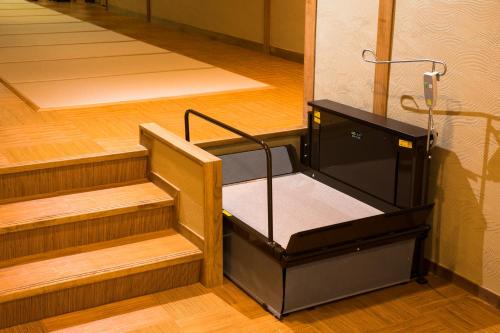 an empty room with wooden floors and wooden stairs at Kagiya in Minamiizu