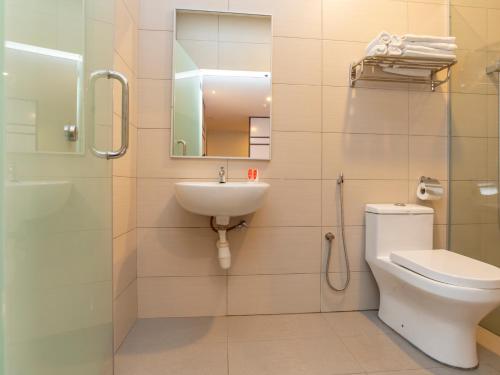 a bathroom with a toilet and a sink and a shower at De Sweet Boutique Hotel in Johor Bahru