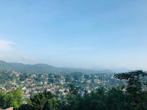 a view of a city with mountains in the background at The Heaven's Villa Kandy in Kandy