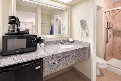 a bathroom with a sink and a microwave at Hotel Nexus; BW Signature Collection in Seattle