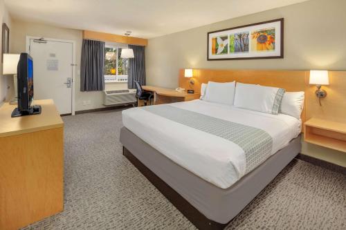 a hotel room with a large bed and a television at Hotel Nexus; BW Signature Collection in Seattle