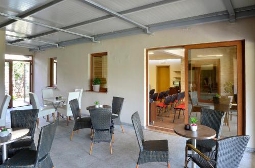 a dining room with tables and chairs and a room with at Hotel Fobra in Podgorica