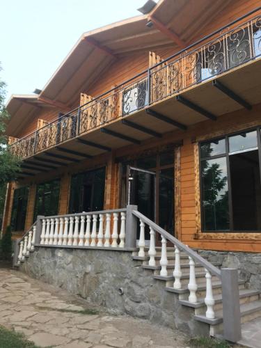a wooden house with a balcony and stairs at Harsnadzor Eco Resort in Halidzor