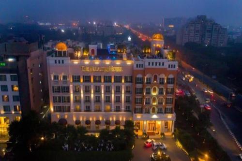 
a large building with a large clock on the side of it at The Pllazio Hotel in Gurgaon
