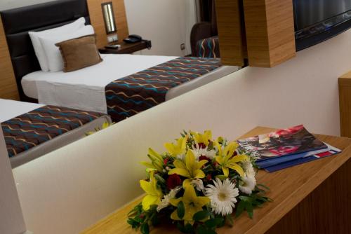 a bouquet of flowers on a table in a hotel room at North Point Hotel in Denizli