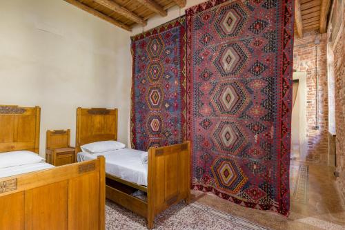 a bedroom with two beds and a red wall at Spazio Seicentesco in Verona