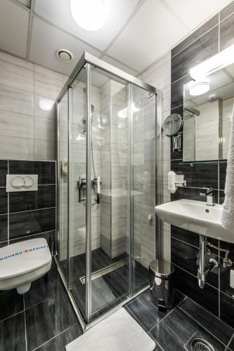 a bathroom with a glass shower and a sink at Hotel Fontana Vrnjačka Banja in Vrnjačka Banja