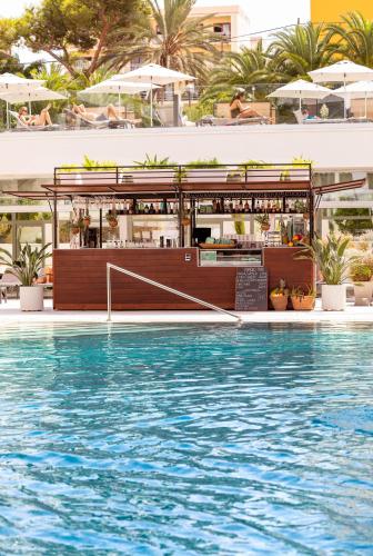 a swimming pool with a bar in the middle of a building at INNSiDE by Meliá Palma Bosque in Palma de Mallorca