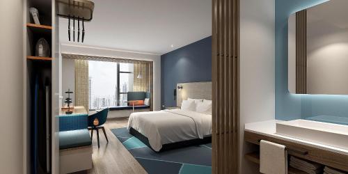 a hotel room with a bed and a bathroom at Holiday Inn Express Zhoushan Dinghai, an IHG Hotel in Zhoushan