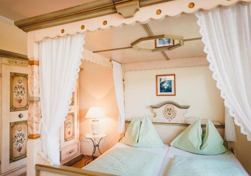 a bedroom with a bed with a canopy at Landgasthof Gietl in Kammern im Liesingtal