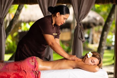 a woman getting a massage from a therapist at South Palms Resort Panglao in Panglao Island