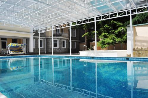 a large swimming pool with blue water at Hotel Imperial 2011 in Yalta