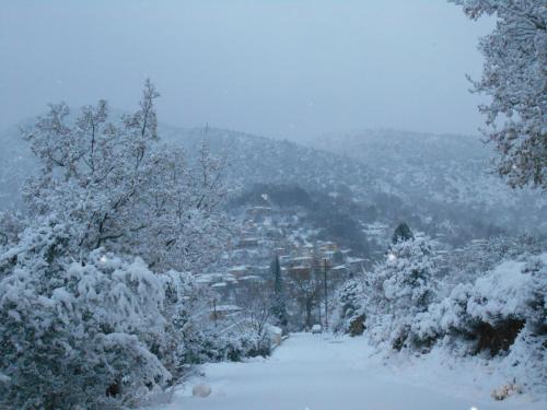 a snow covered hill with a city in the distance at Wanderer's Lodge in Sparti