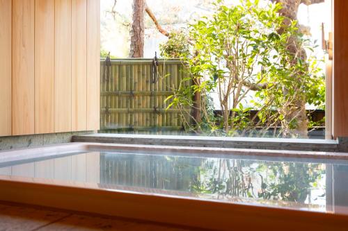 a swimming pool in front of a window at Kamakura COCON in Kamakura