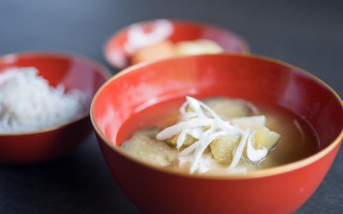 a red bowl of soup with onions in it at Kamakura COCON in Kamakura