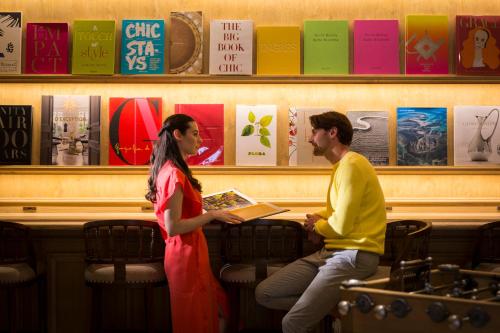 a man and a woman sitting in a bar talking at Hotel Francs in Chiba