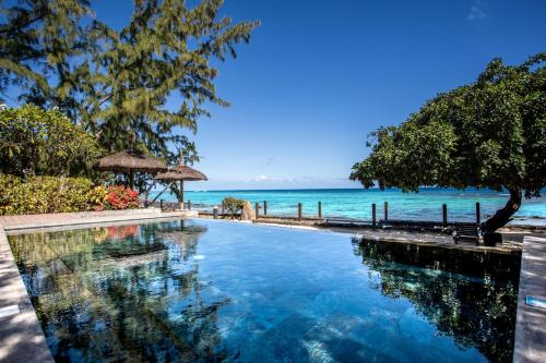 a swimming pool with the ocean in the background at Belle Crique B1 in Tamarin
