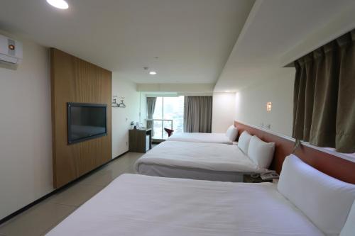 Yi Dian Yuan Hotel tesisinde bir odada yatak veya yataklar