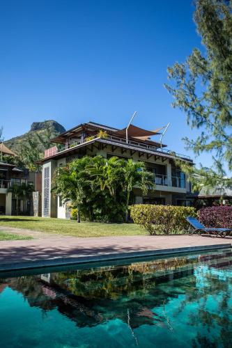 a resort with a pool in front of a building at Belle Crique B1 in Tamarin