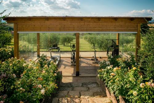 a pavilion in a garden with bikes and flowers at Tenuta dei Mori-Wine Relais Events in Villanova