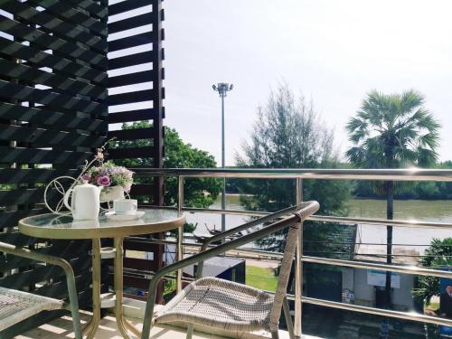 a table and chairs on a balcony with a view at Krabi River View Hotel in Krabi town
