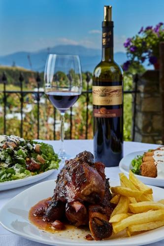 a table with plates of food and a glass of wine at Casa Mare in Nimfaíon