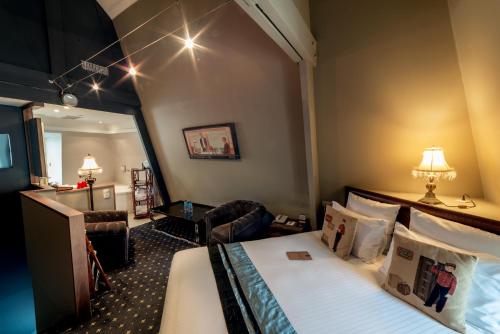 a hotel room with a bed and a mirror at Royal Emeraude Hotel Dinard - MGallery Collection in Dinard