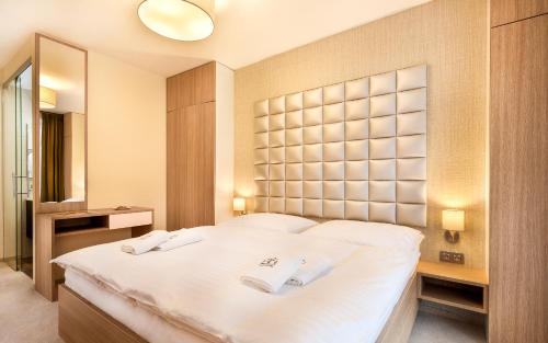 Postel nebo postele na pokoji v ubytování Apartmánový Hotel HREBIENOK RESORT