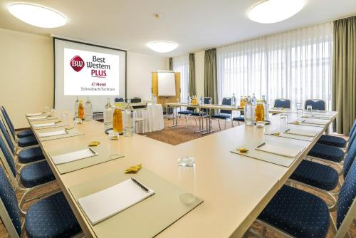 a conference room with a long table and chairs at Best Western Plus iO Hotel in Eschborn