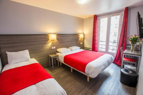 a hotel room with two beds and a window at Hipotel Paris Père-Lachaise République in Paris