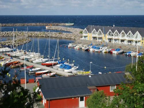 a marina with boats in the water next to houses at 6 person holiday home in Hasle in Hasle