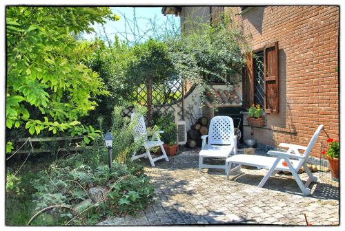 a patio with two chairs and a table at La Corte del Macero in Castelfranco Emilia