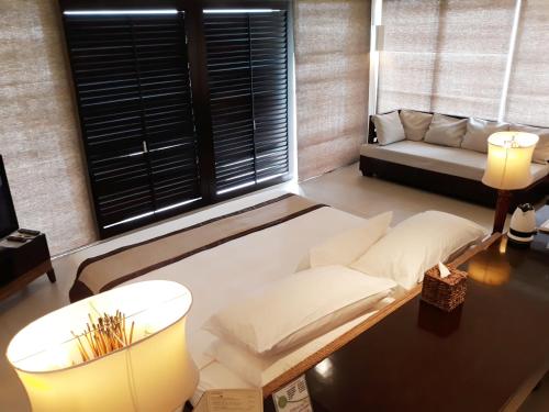 a living room with a couch and a table at Kamana Sanctuary Resort & Spa in Olongapo