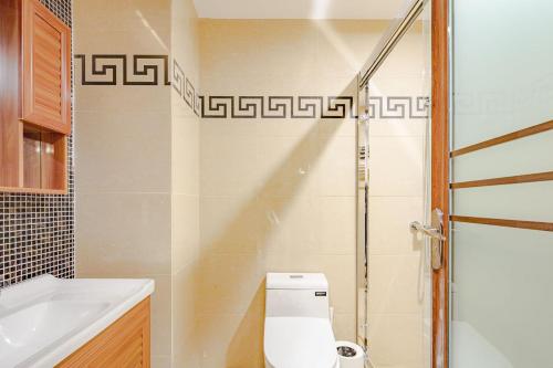 a bathroom with a toilet and a sink and a shower at Qingyang Wenshuyuan· Chengdu in Chengdu