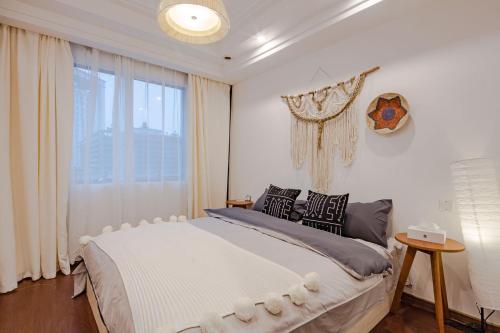 um quarto com uma cama grande e uma janela em Qingyang Wenshuyuan· Chengdu em Chengdu