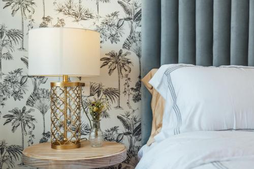 a bedroom with a bed and a lamp on a table at [Roader] Wuhan Jianghan District, Xinhua Road in Wuhan
