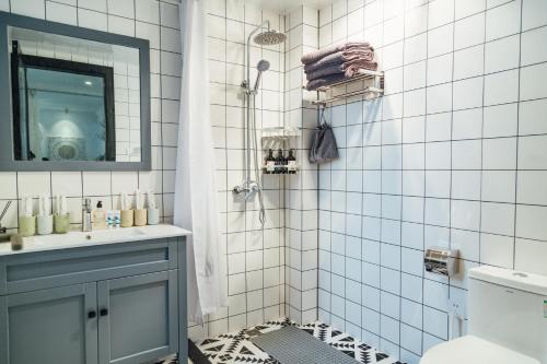 a bathroom with a shower with a sink and a mirror at [Roader] Wuhan Jianghan District, Xinhua Road in Wuhan