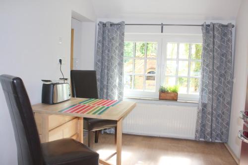 a kitchen with a table and a window at Ferienwohnung Gartenblick in Westerstede