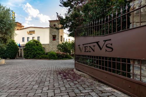 a fence on the side of a brick road at Hotel Villa Venus Resort & SPA in Atena Lucana