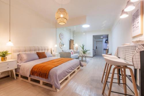 a bedroom with a large bed and a living room at [Roader] Wuhan Jiang'an District, Hong Kong Road in Wuhan