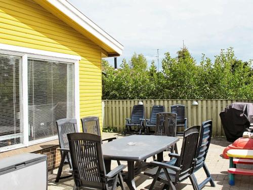 a patio with a table and chairs and a fence at 6 person holiday home in V ggerl se in Bøtø By