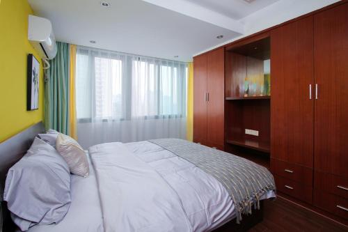 a bedroom with a large bed and a cabinet at Nanjing·Xin Street Entrance·Zhujiang Road· in Nanjing